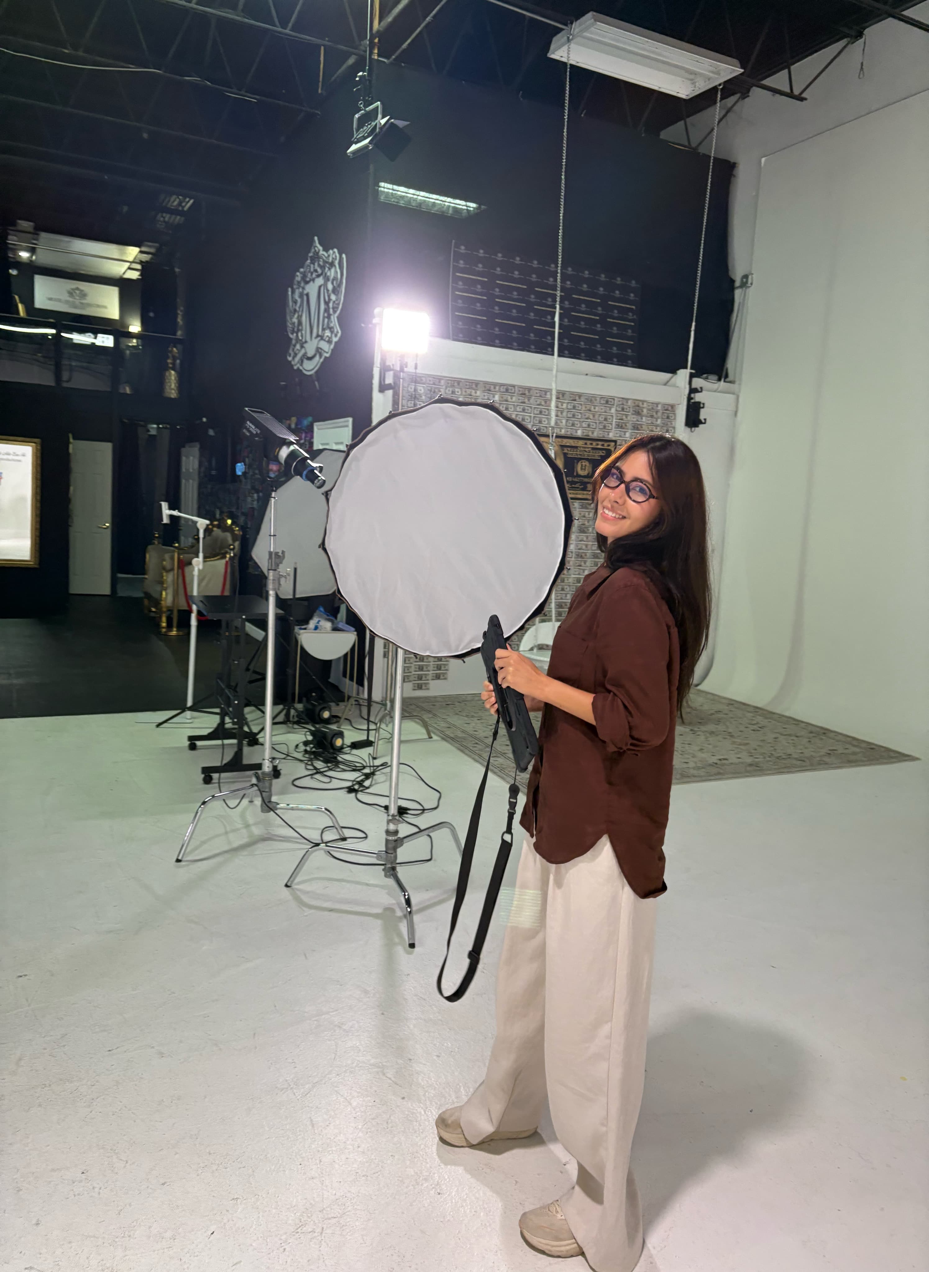 Lu holding reflector in studio